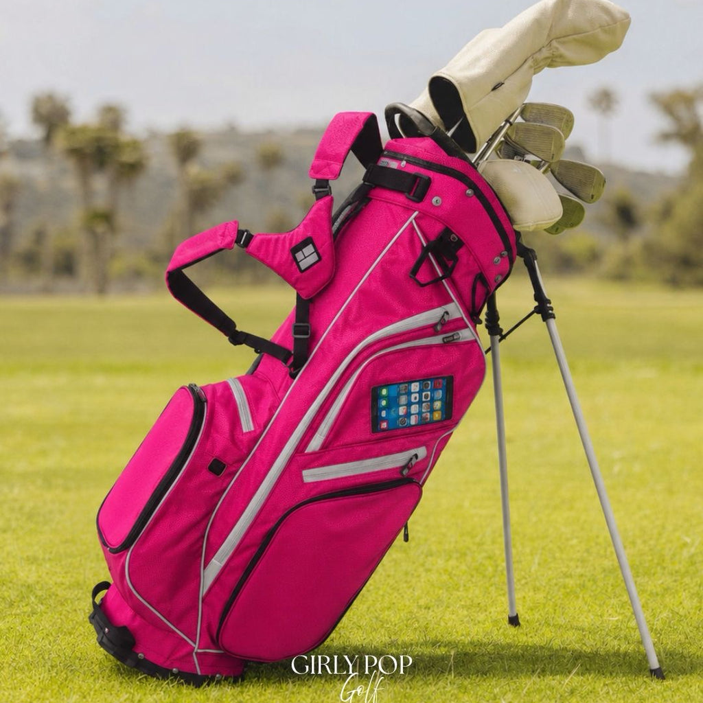 Pink golf bag with clubs on a grassy field, featuring 'GIRLY POP Golf' branding.