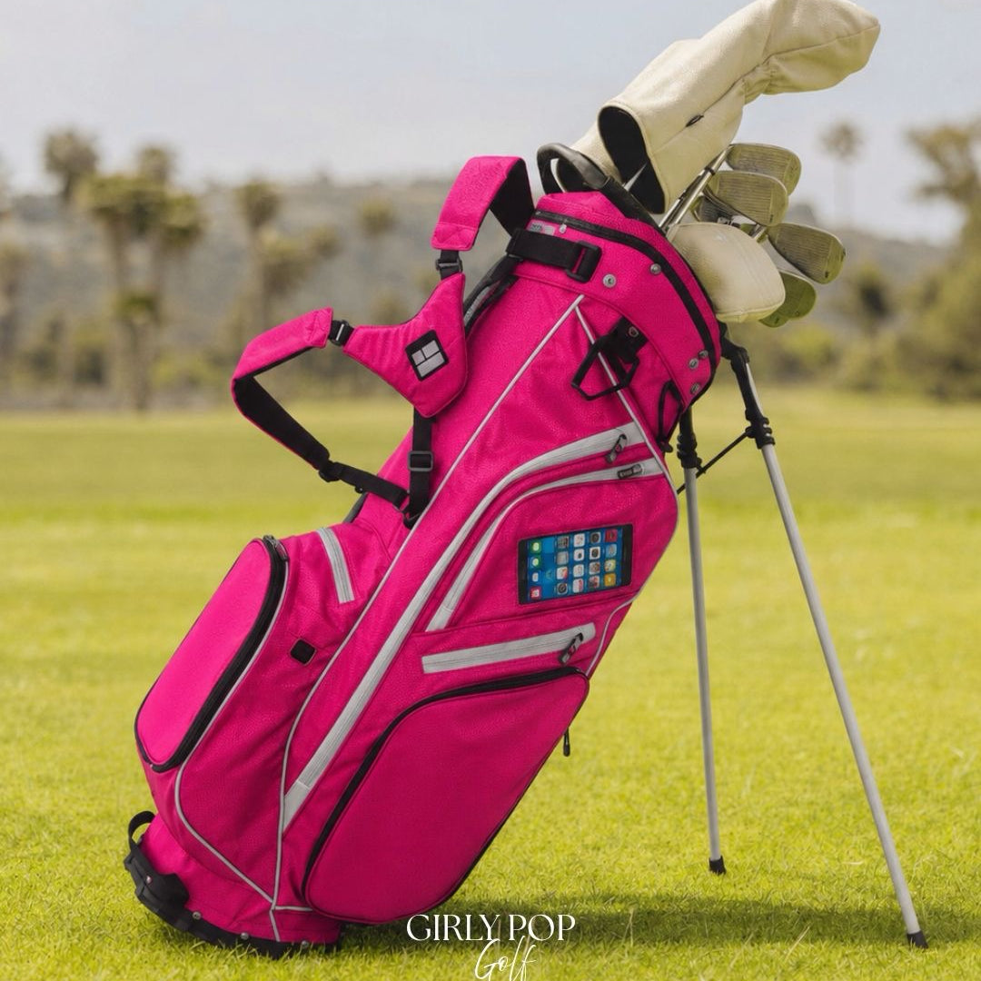 Pink golf bag with clubs on a grassy field, featuring 'GIRLY POP Golf' branding.