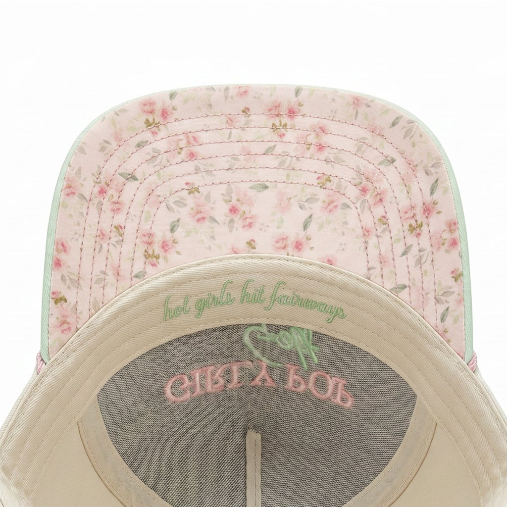 Baseball cap with floral pattern on top and text on the brim against a white background