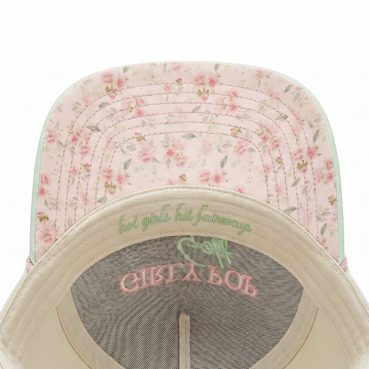 Baseball cap with floral pattern on top and text on the brim against a white background