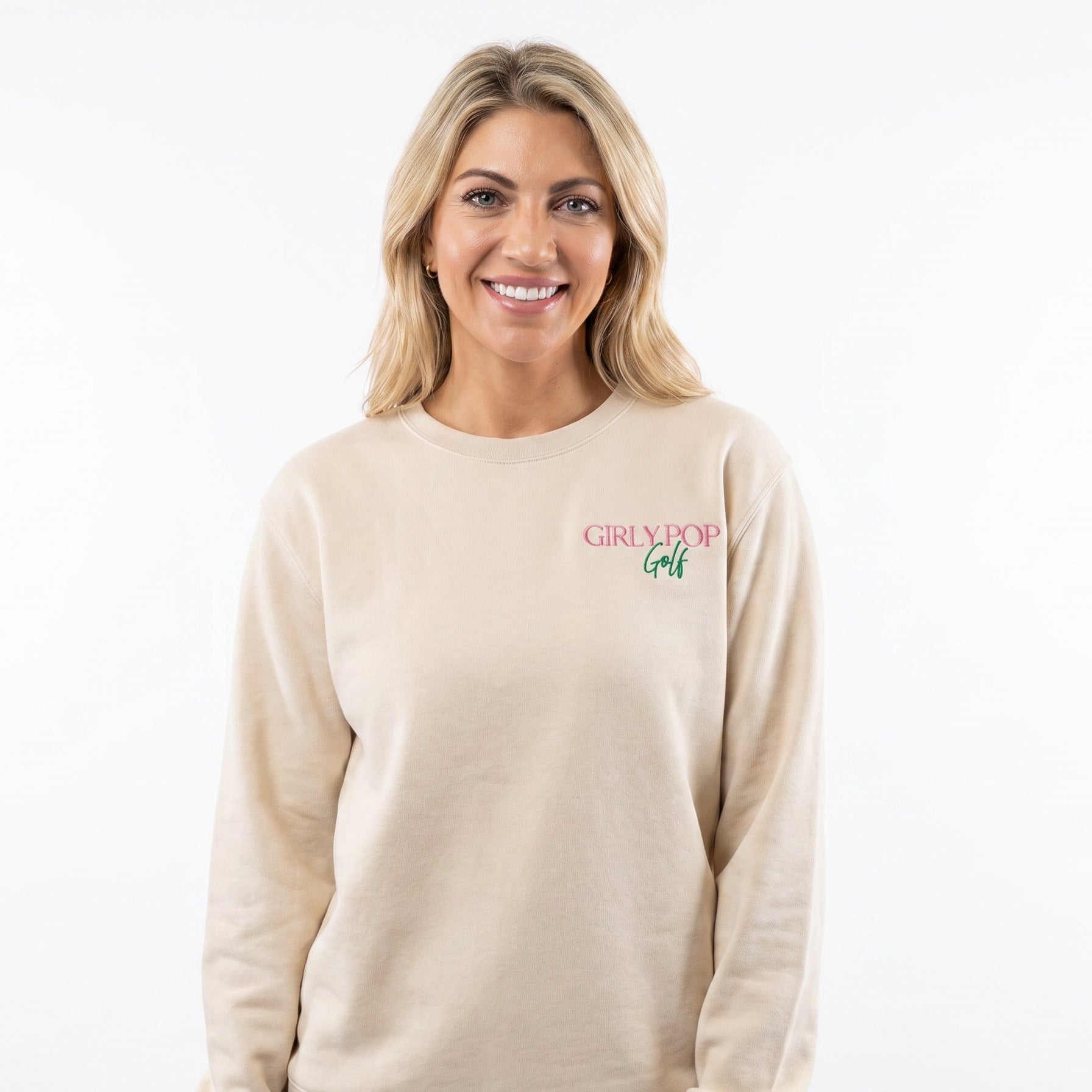Woman wearing a beige sweatshirt with a logo on a white background