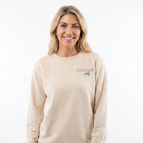 Woman wearing a beige sweatshirt with a logo on a white background