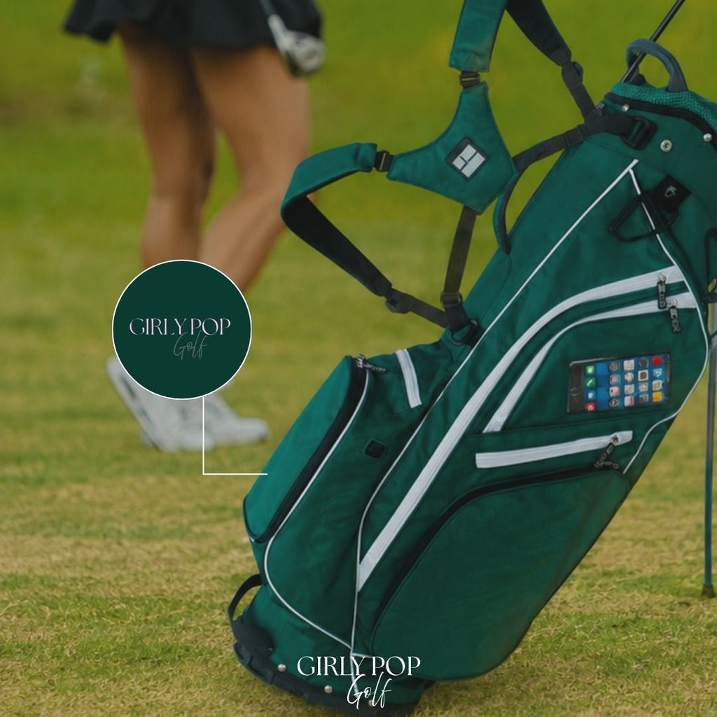 Green golf bag with 'Girly Pop Golf' branding on a grassy field.